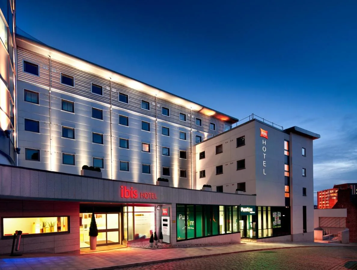 a building with a woman standing in front of it at ibis Aberdeen Centre – Quayside in Aberdeen